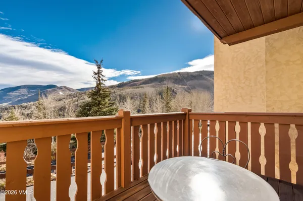 a balcony with wooden floor and fence
