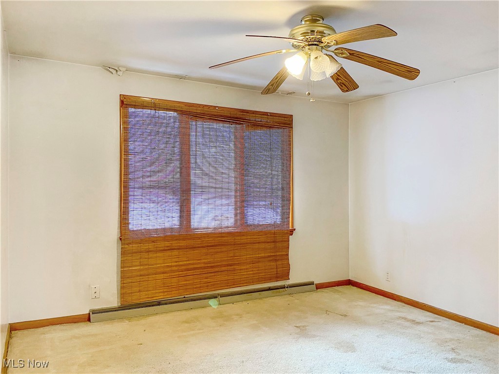 1034 Straub Road West Mansfield, OH 44904 - Photo 16 of 27 Carpeted empty room featuring ceiling fan and baseboard heating