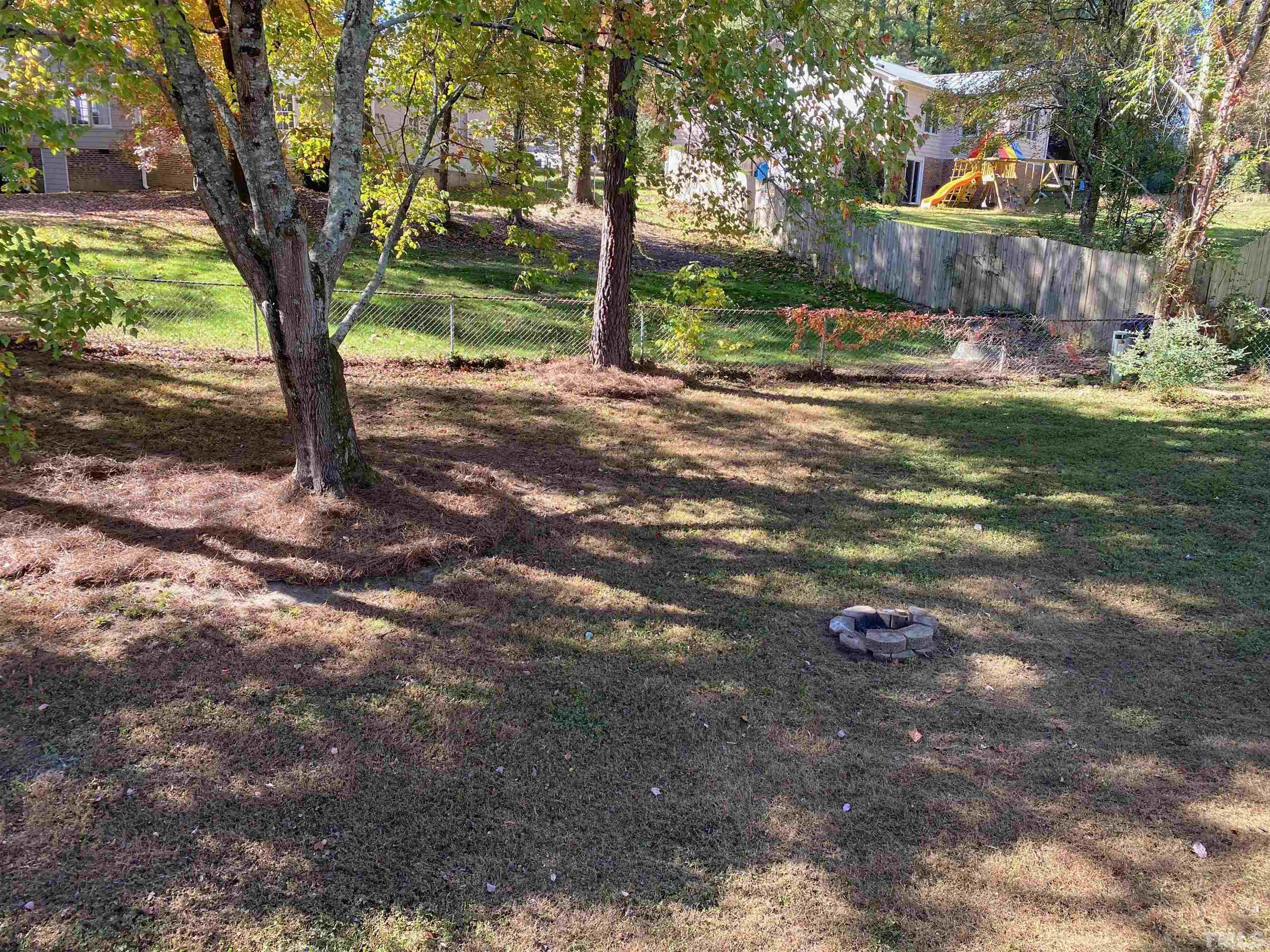6929 Three Bridges Circle Raleigh, NC 27613 - Photo 11 of 28 a backyard of a house with lots of green space