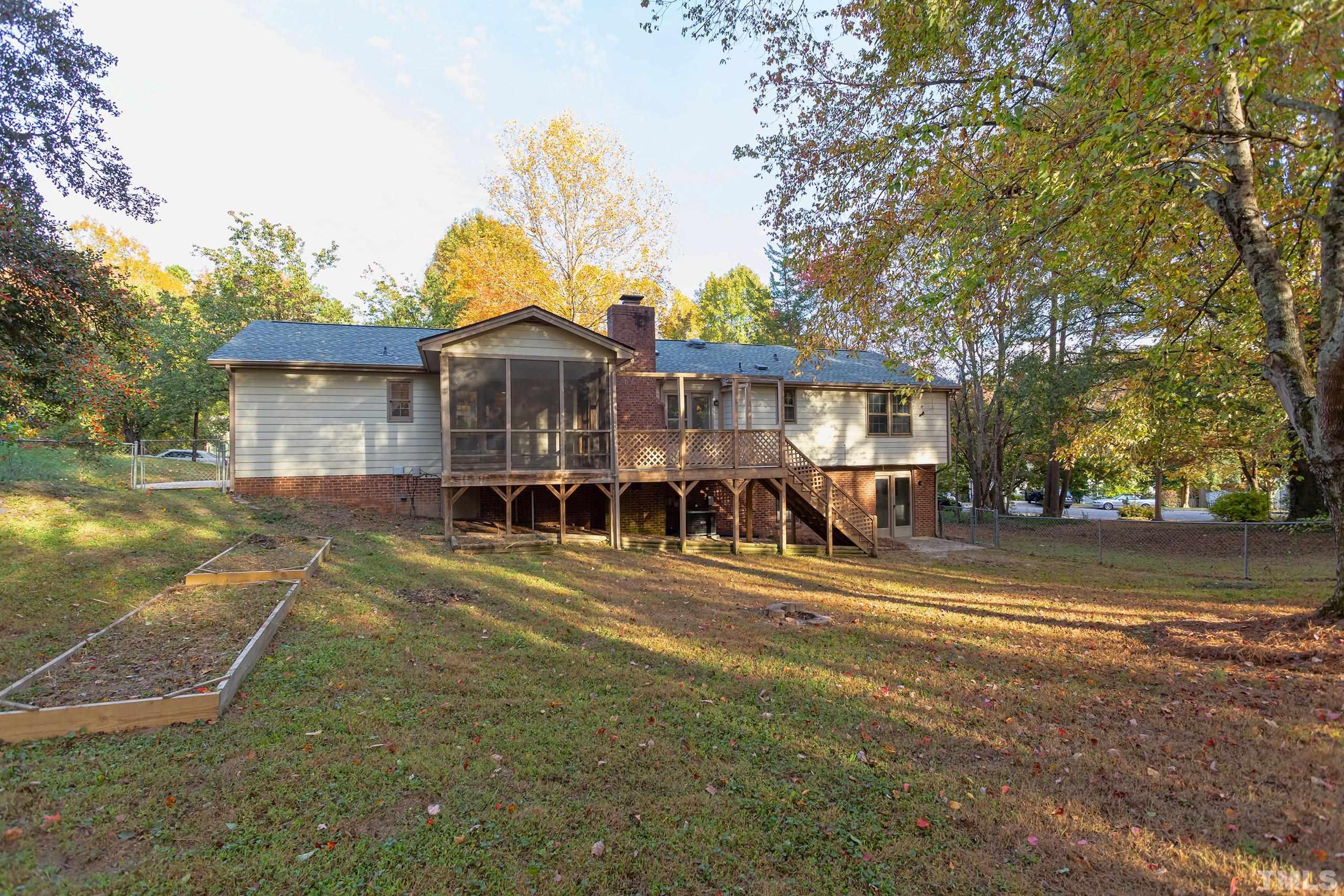 6929 Three Bridges Circle Raleigh, NC 27613 - Photo 15 of 28 a view of a house with a yard and potted plants
