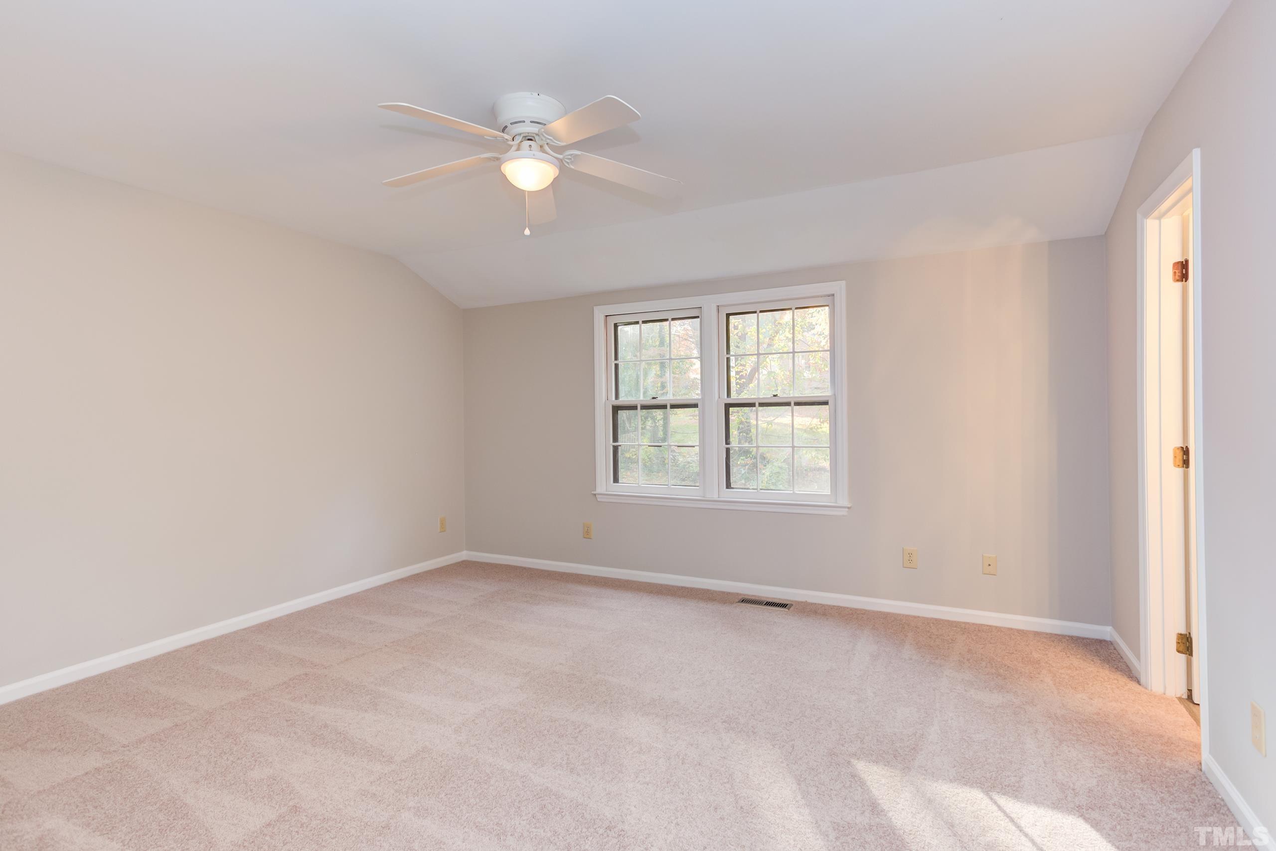 6929 Three Bridges Circle Raleigh, NC 27613 - Photo 18 of 28 an empty room with windows and fan