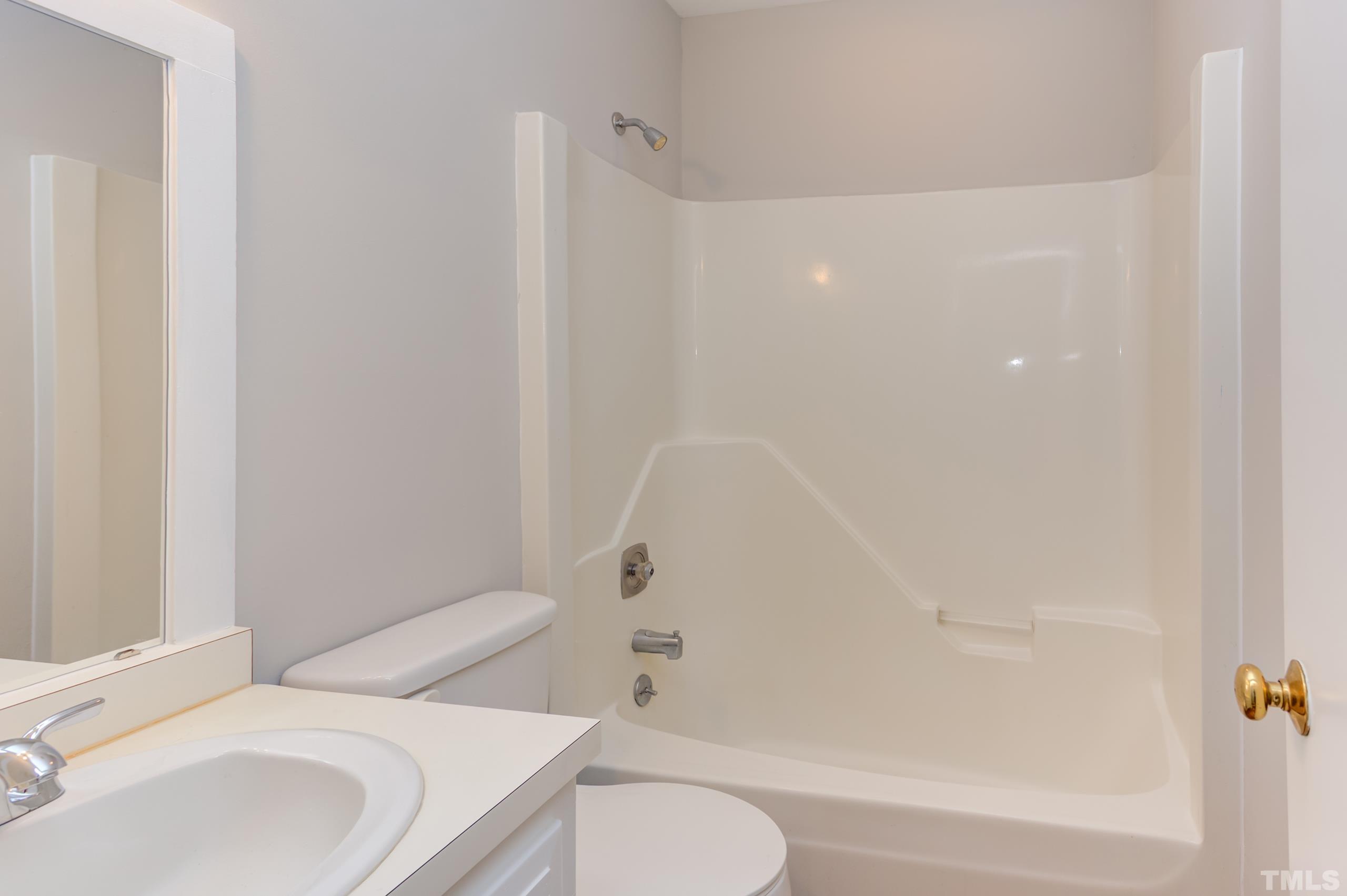 6929 Three Bridges Circle Raleigh, NC 27613 - Photo 19 of 28 a bathroom with a toilet and a bathtub