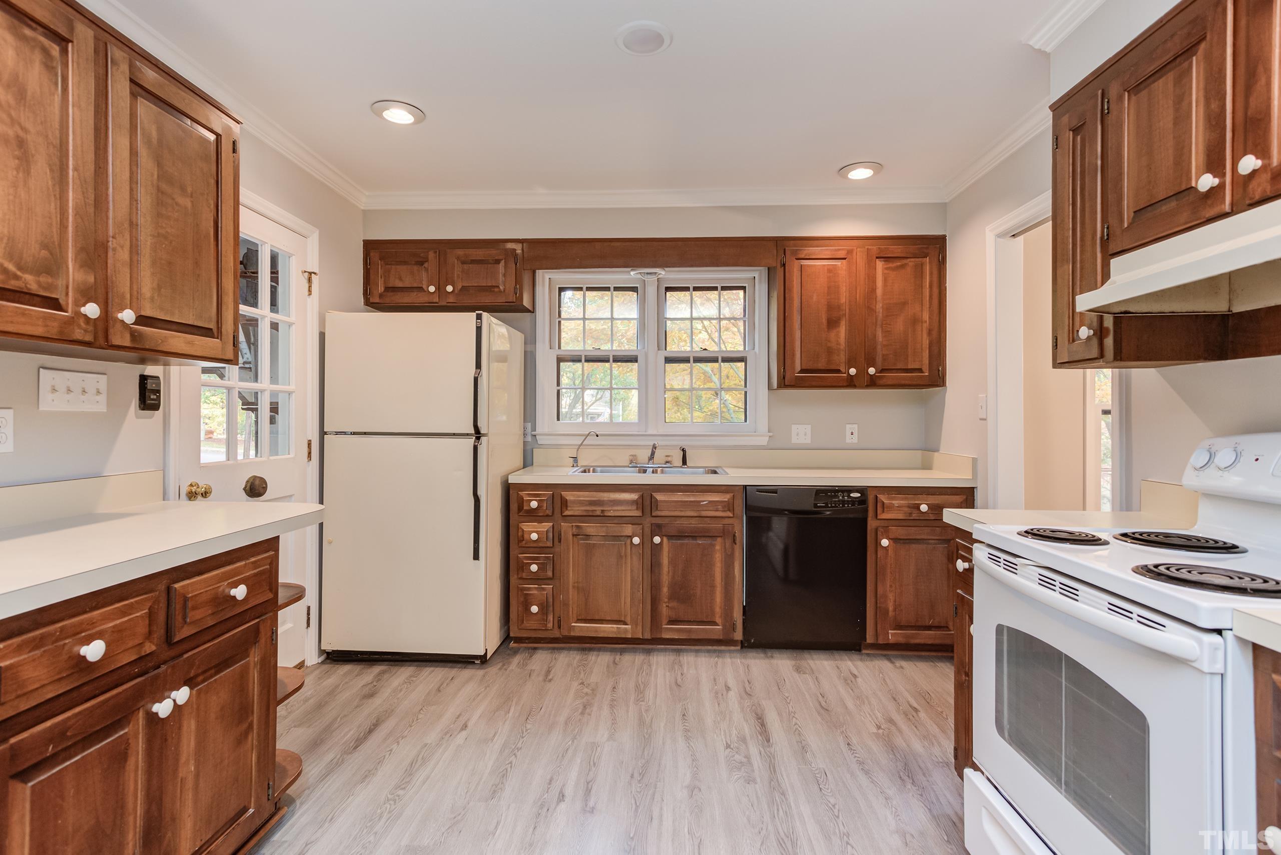 6929 Three Bridges Circle Raleigh, NC 27613 - Photo 21 of 28 a kitchen with a refrigerator stove and sink