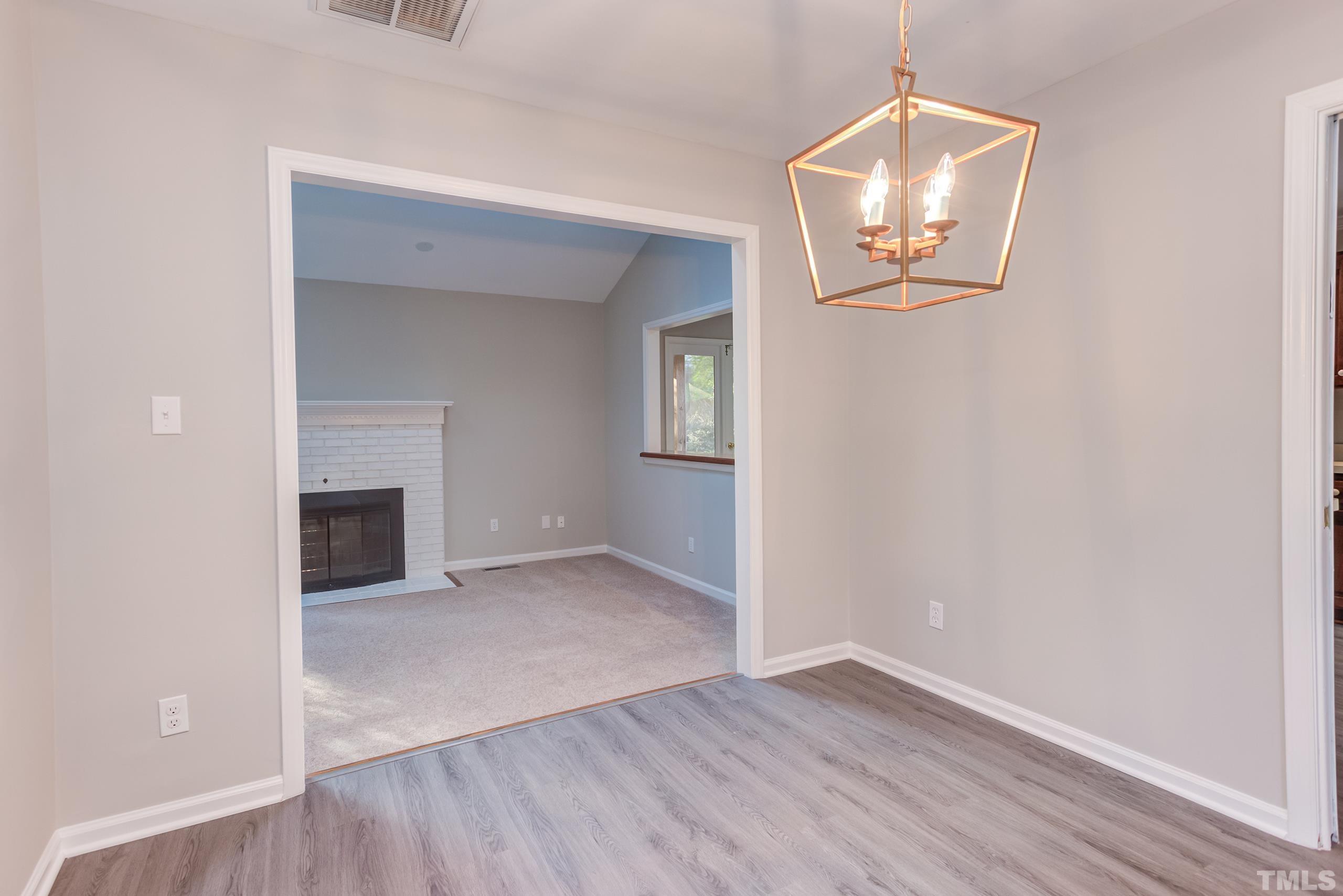 6929 Three Bridges Circle Raleigh, NC 27613 - Photo 28 of 28 an empty room with wooden floor cabinet and hallway