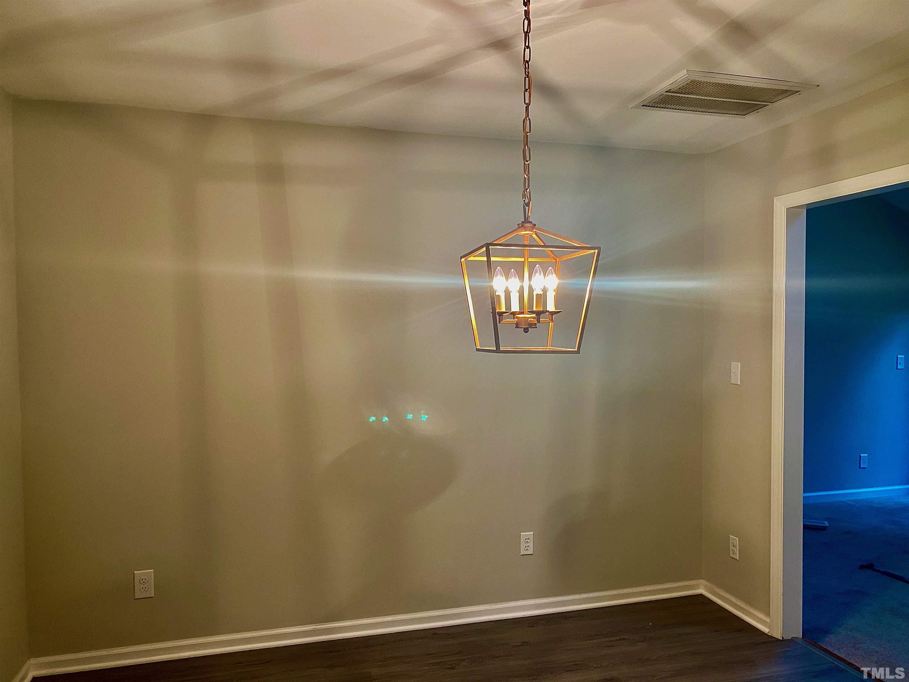 6929 Three Bridges Circle Raleigh, NC 27613 - Photo 5 of 28 a view of a livingroom with a chandelier fan