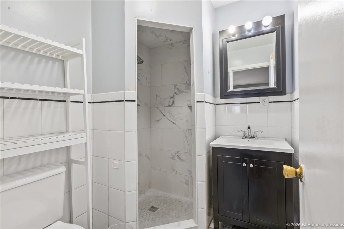 18847 May Avenue Homewood, IL 60430 - Photo 12 of 26 a bathroom with a sink a vanity and a mirror