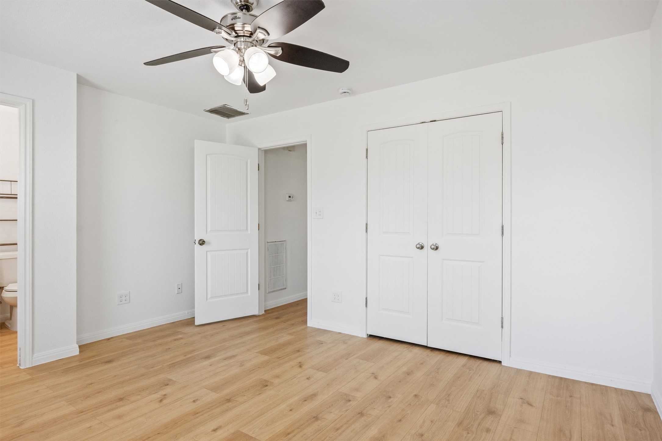 4516 Kind Way, Unit 253 Austin, TX 78725 - Photo 20 of 31 a view of an empty room and chandelier fan
