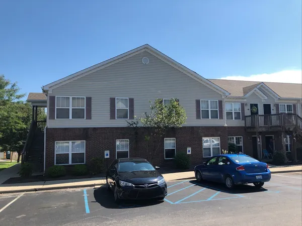 a car parked in front of a brick house