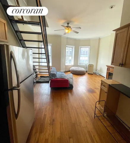 a view of a hallway with wooden floor windows and livingroom