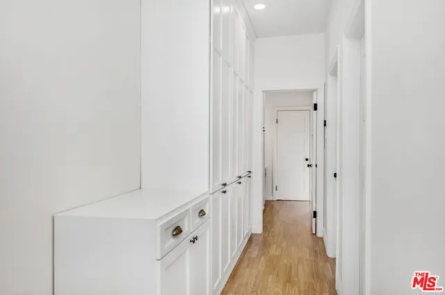 a view of a hallway with wooden floor