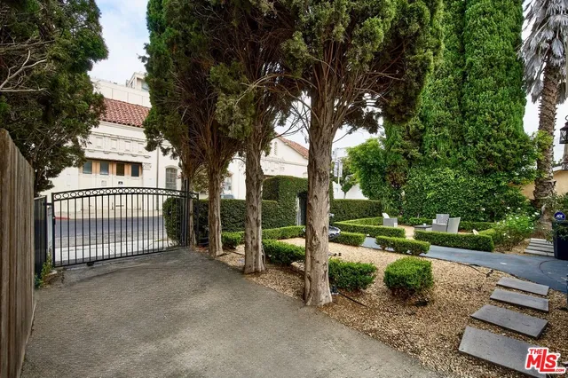 a view of a house with a yard and tree s