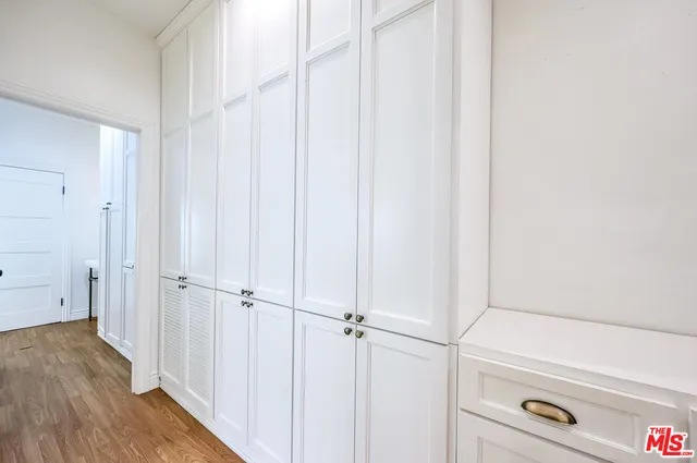 a view of a hallway with wooden floor