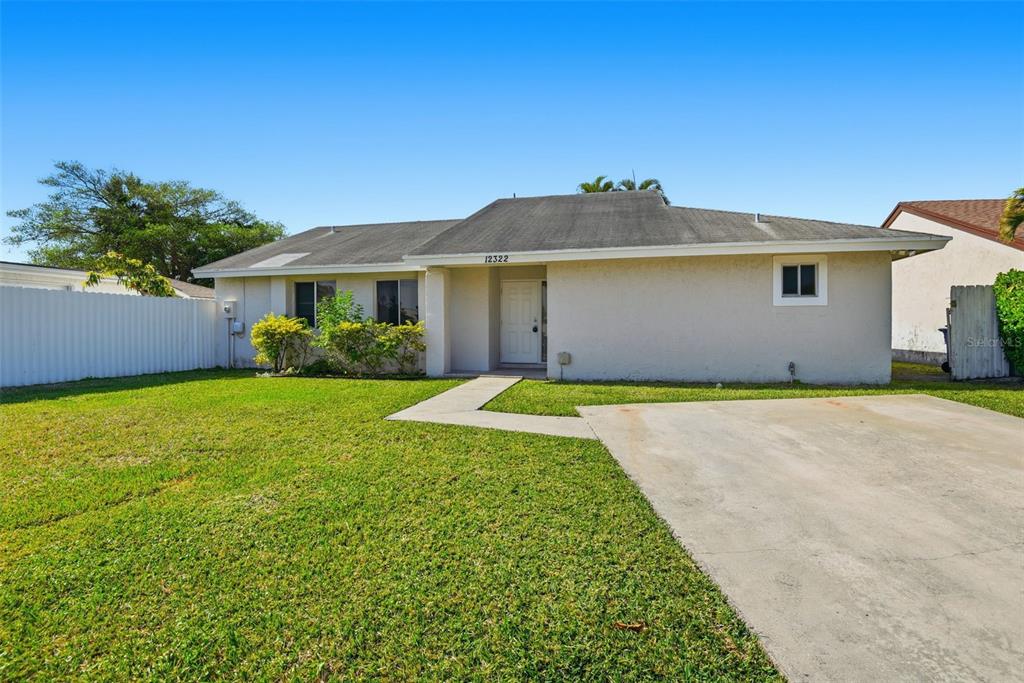 12322 Southwest 209th Street Miami, FL 33177 - Photo 1 of 1 a front view of a house with a garden