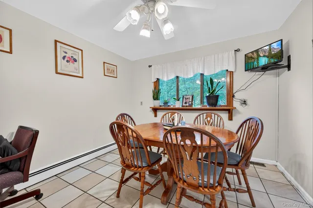 a dining room with furniture and window