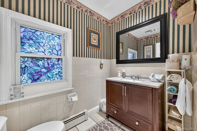 a bathroom with a toilet a sink and mirror