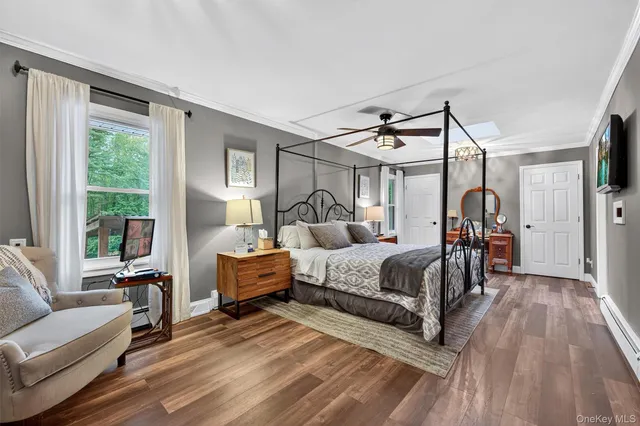 a bedroom with a bed couch and a window