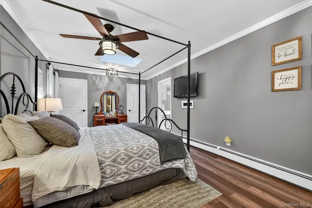a bedroom with a bed and ceiling fan
