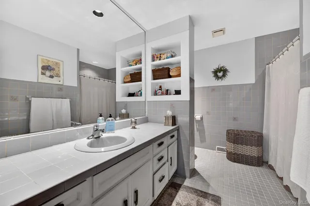 a bathroom with a sink double vanity and a shower