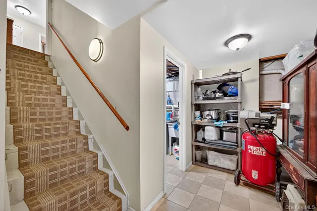 a view of a livingroom with furniture and staircase