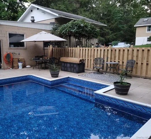 a view of backyard with sitting area and furniture