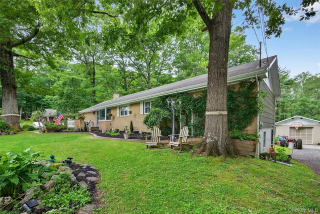 a view of a house with a backyard and a patio