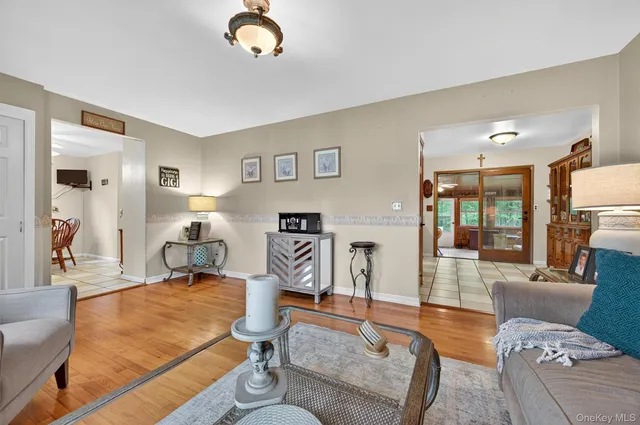 a living room with furniture gym equipment and a large window