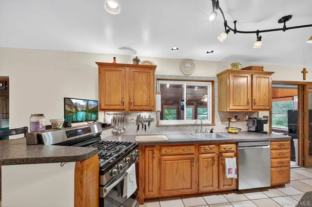 a kitchen with stainless steel appliances granite countertop a sink stove and cabinets