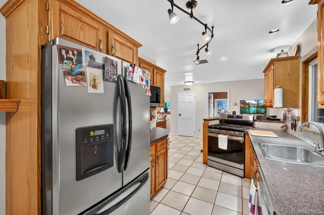 a kitchen with stainless steel appliances granite countertop a refrigerator and a stove