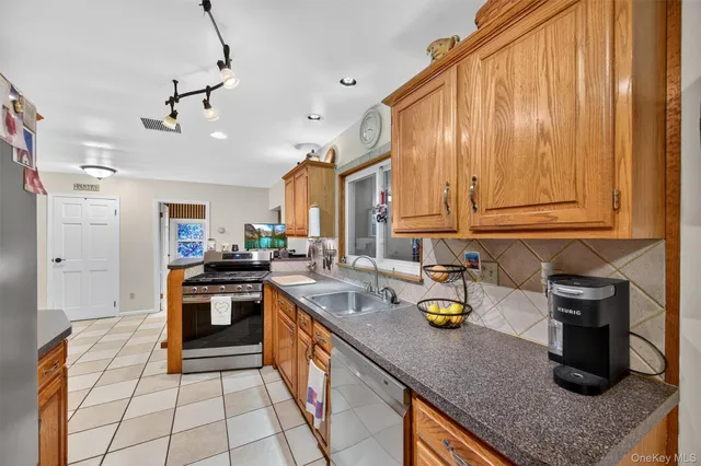 a kitchen with sink cabinets and appliances