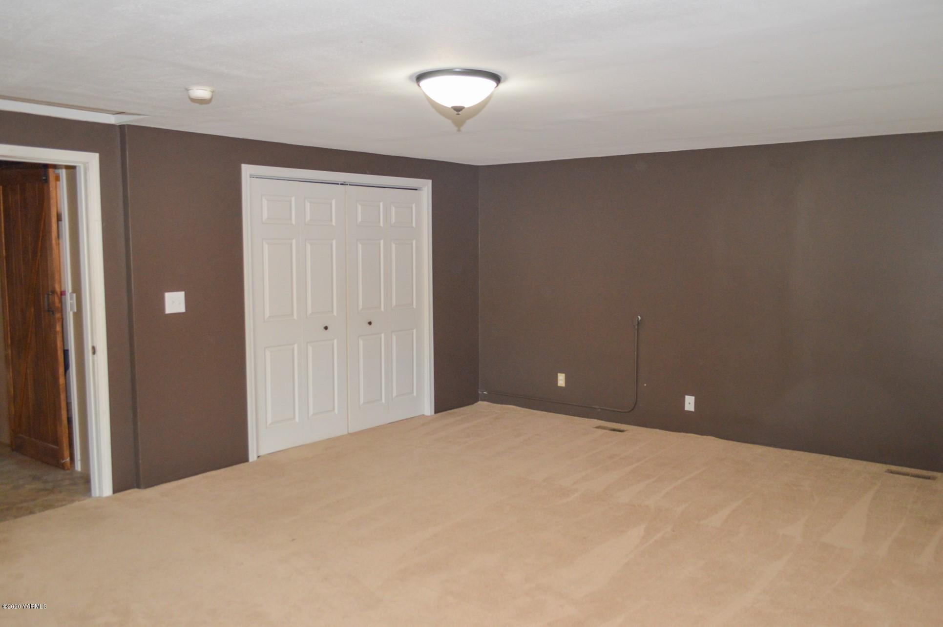 250 West Canyon Road Yakima, WA 98908 - Photo 11 of 27 a view of a room with a chandelier fan and a window