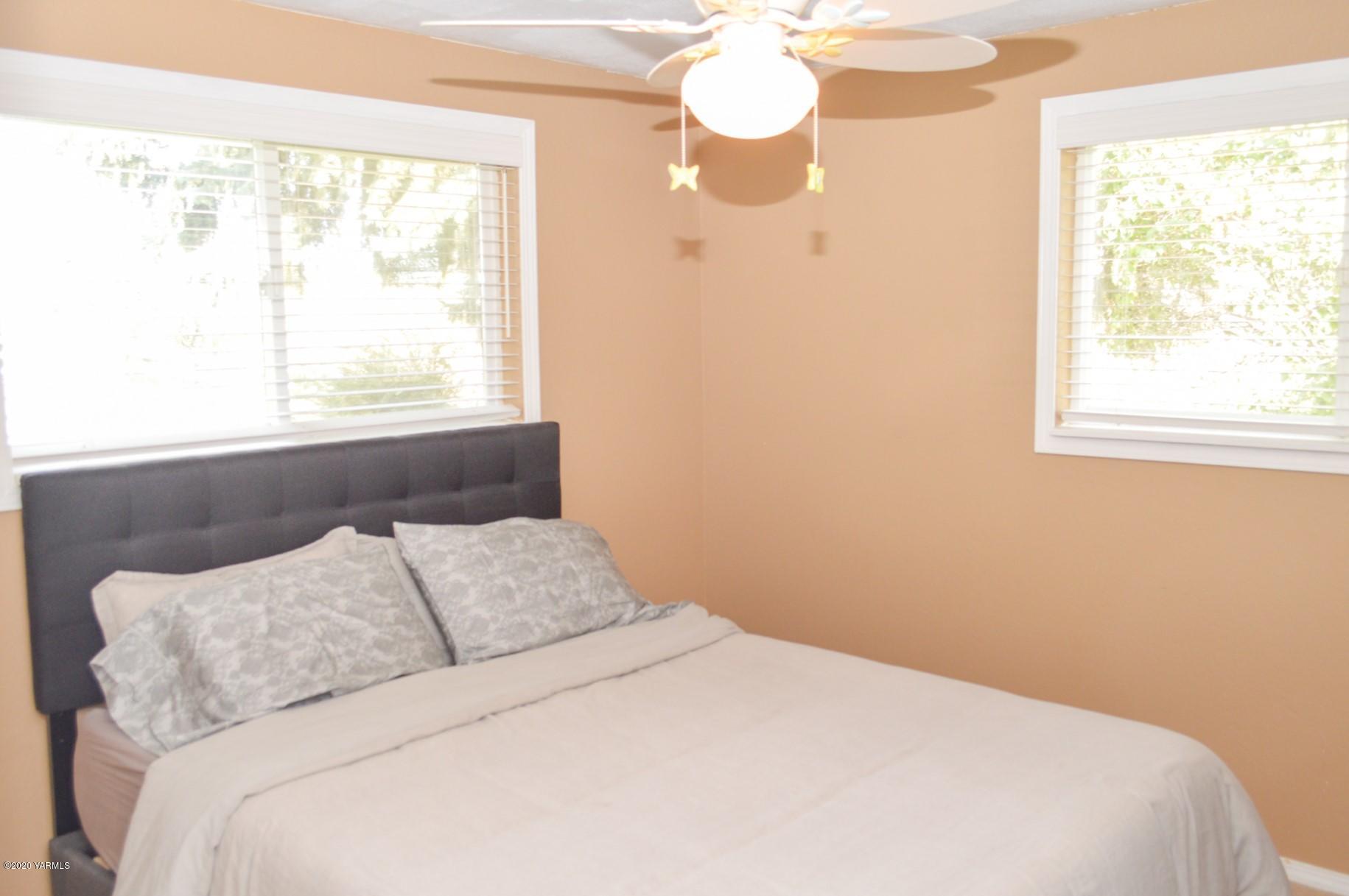 250 West Canyon Road Yakima, WA 98908 - Photo 12 of 27 a bedroom with a bed and a window
