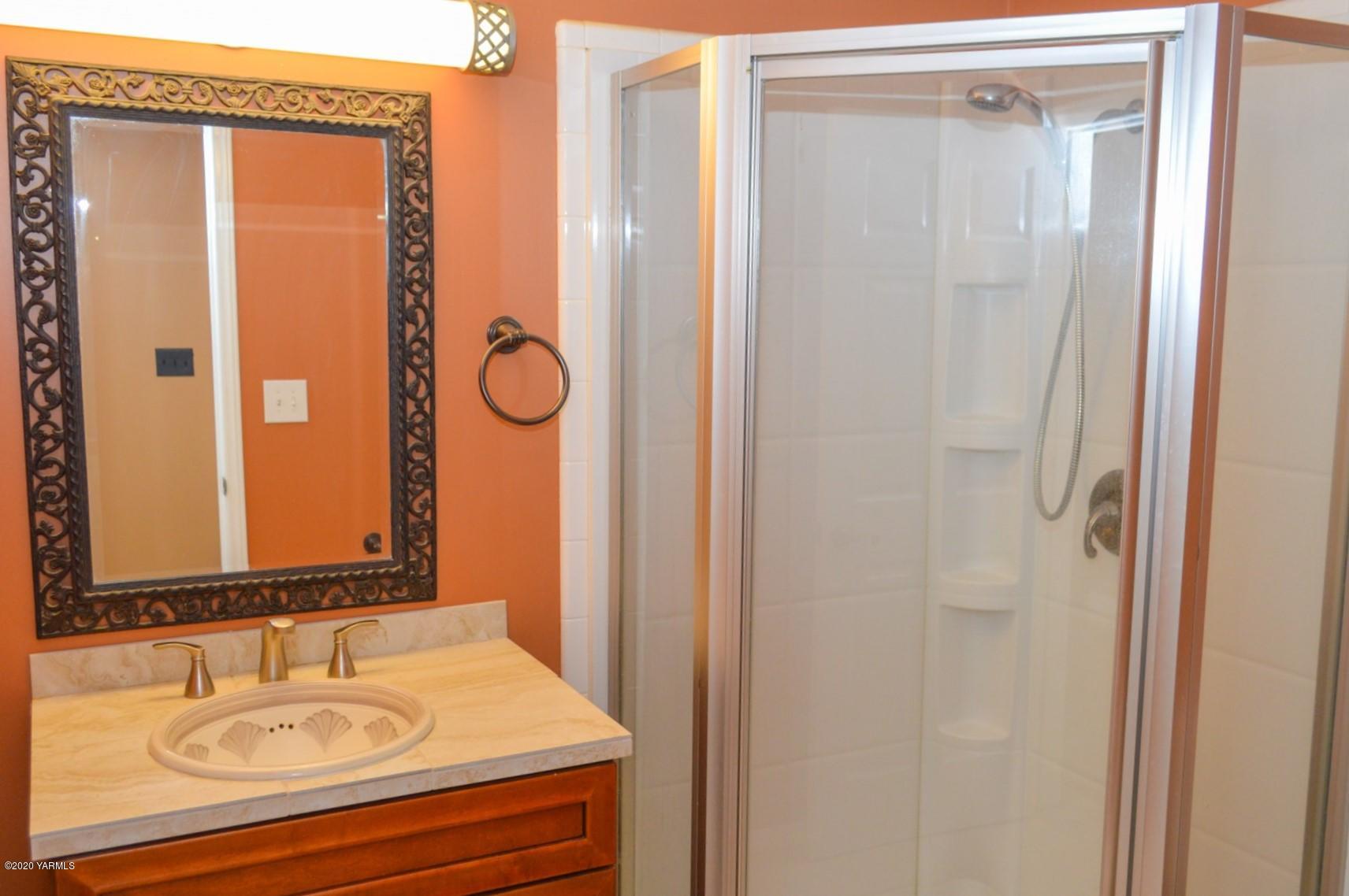 250 West Canyon Road Yakima, WA 98908 - Photo 14 of 27 a bathroom with a granite countertop sink and a mirror