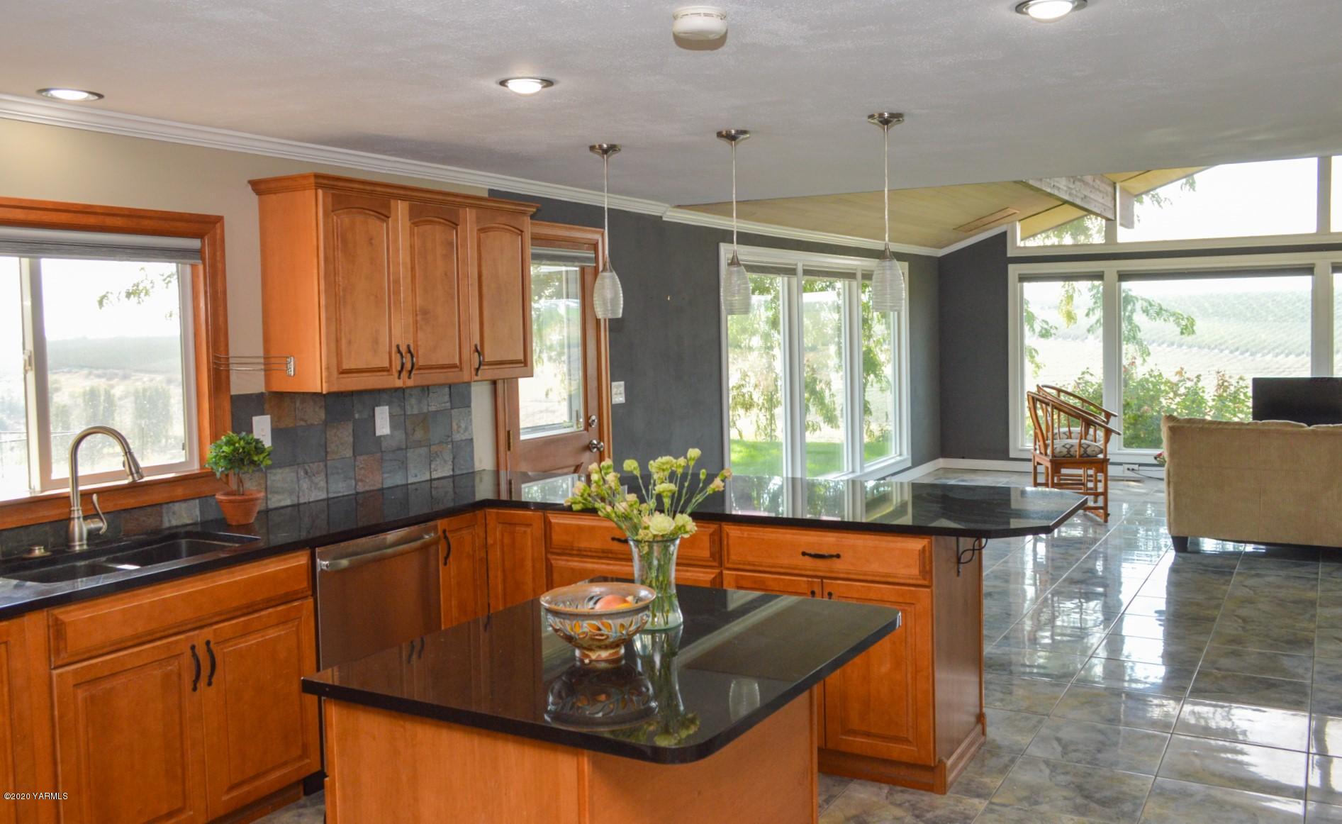 250 West Canyon Road Yakima, WA 98908 - Photo 3 of 27 a kitchen with kitchen island granite countertop a sink and a table