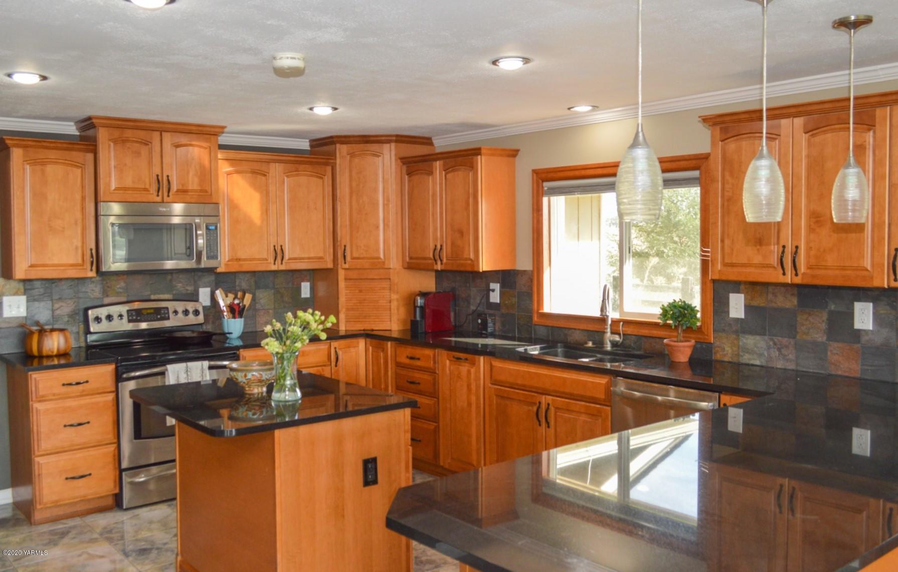 250 West Canyon Road Yakima, WA 98908 - Photo 4 of 27 a kitchen with stainless steel appliances granite countertop sink stove top oven and cabinets