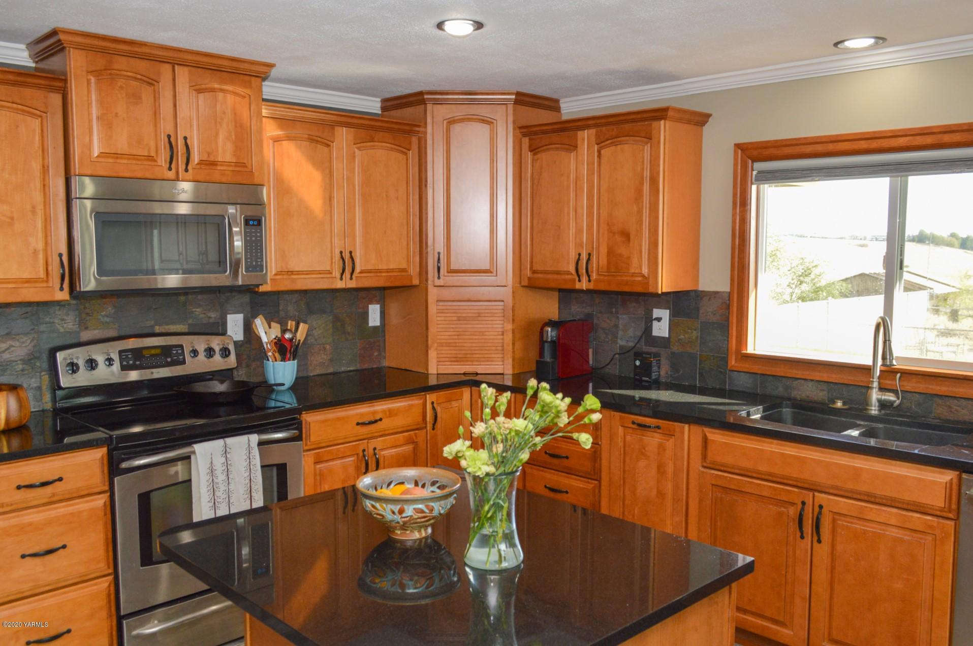 250 West Canyon Road Yakima, WA 98908 - Photo 5 of 27 a kitchen with stainless steel appliances granite countertop a sink a stove and a microwave