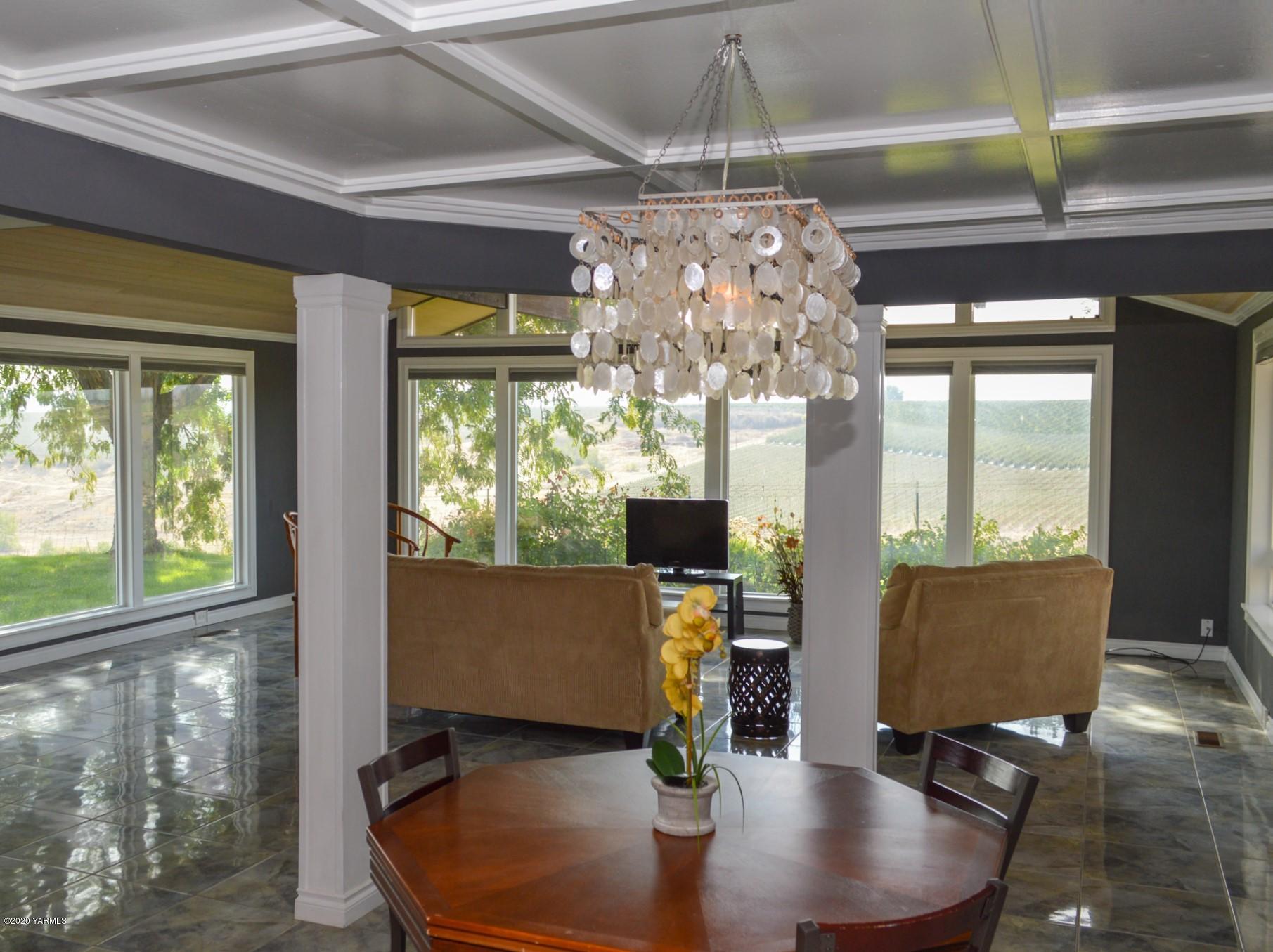 250 West Canyon Road Yakima, WA 98908 - Photo 8 of 27 a dining room with furniture a chandelier and wooden floor