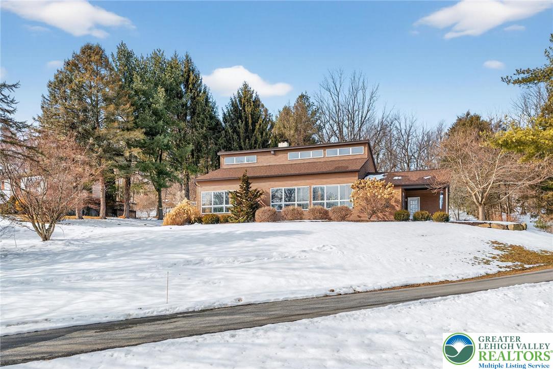 4793 Main Road West Emmaus, PA 18049 - Photo 4 of 81 a front view of a house with a yard and garage