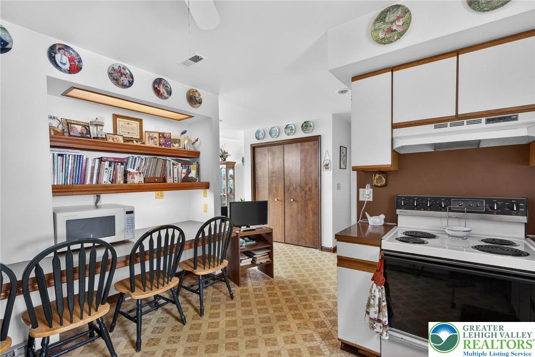 4793 Main Road West Emmaus, PA 18049 - Photo 52 of 81 a kitchen with stainless steel appliances granite countertop a stove a refrigerator and a dining table