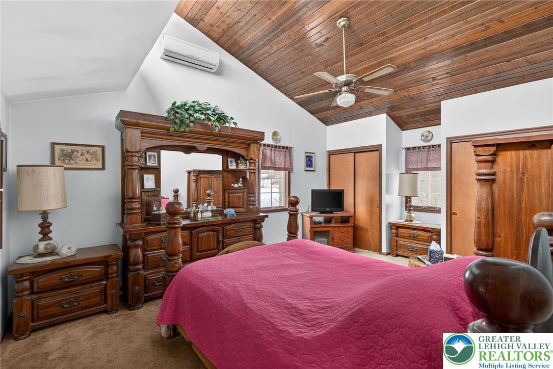 4793 Main Road West Emmaus, PA 18049 - Photo 59 of 81 a bed room with a bed mirror and a chandelier