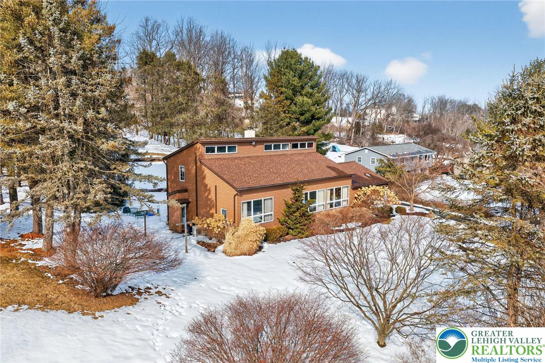 4793 Main Road West Emmaus, PA 18049 - Photo 6 of 81 a view of a house with a yard covered in snow
