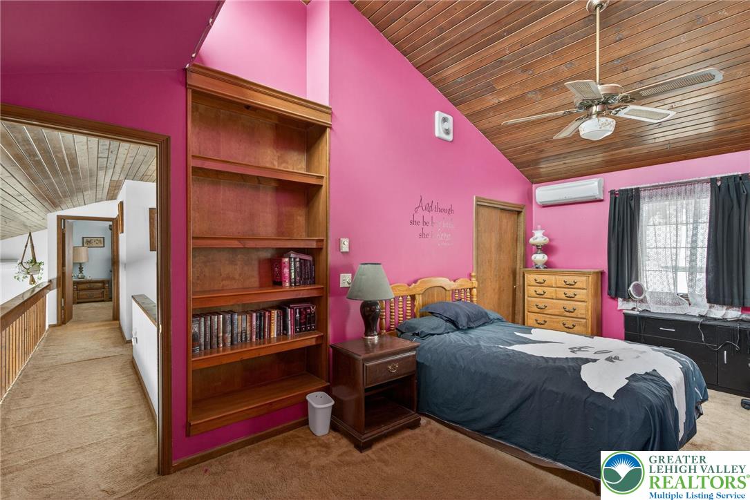 4793 Main Road West Emmaus, PA 18049 - Photo 65 of 81 a bedroom with a bed and a bookshelf