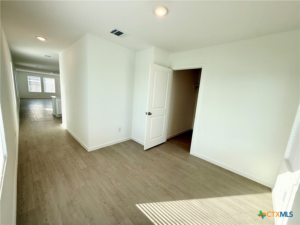 311 Moscato Road New Braunfels, TX 78130 - Photo 33 of 38 a view of a hallway with wooden floor and closet area
