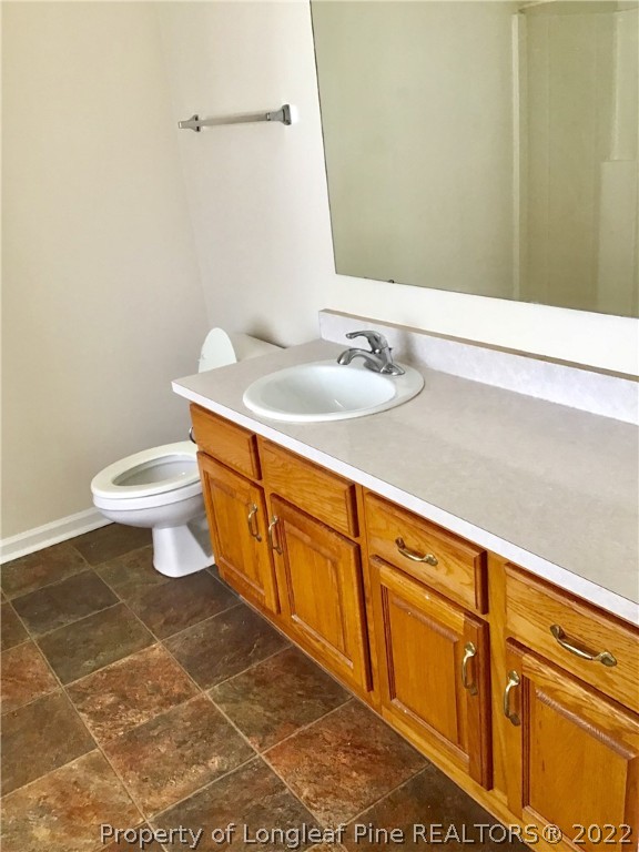 1824 Sardonyx Road, Unit 2 Fayetteville, NC 28303 - Photo 18 of 20 a bathroom with a sink a toilet and a mirror