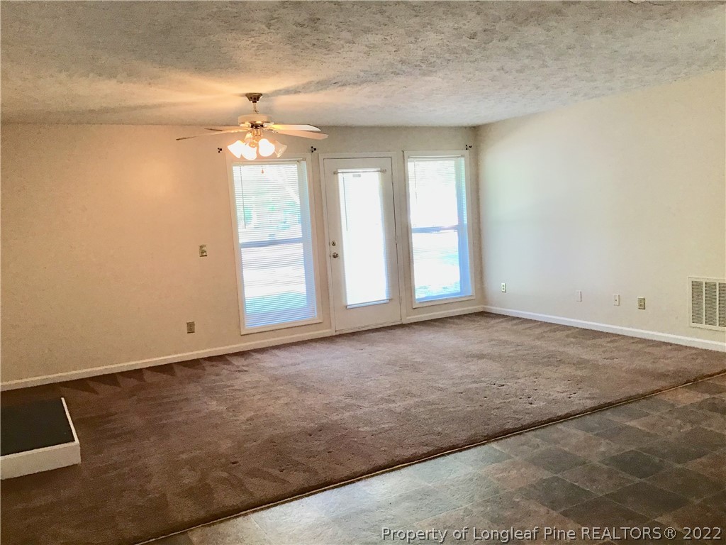 1824 Sardonyx Road, Unit 2 Fayetteville, NC 28303 - Photo 3 of 20 en empty room with windows and ceiling fan