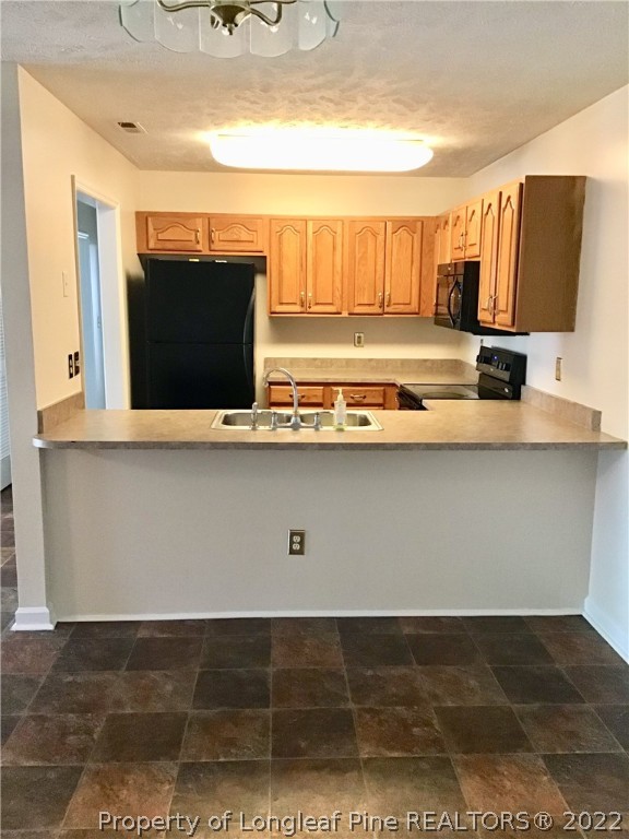1824 Sardonyx Road, Unit 2 Fayetteville, NC 28303 - Photo 6 of 20 a view of kitchen with stainless steel appliances wooden floor and screen