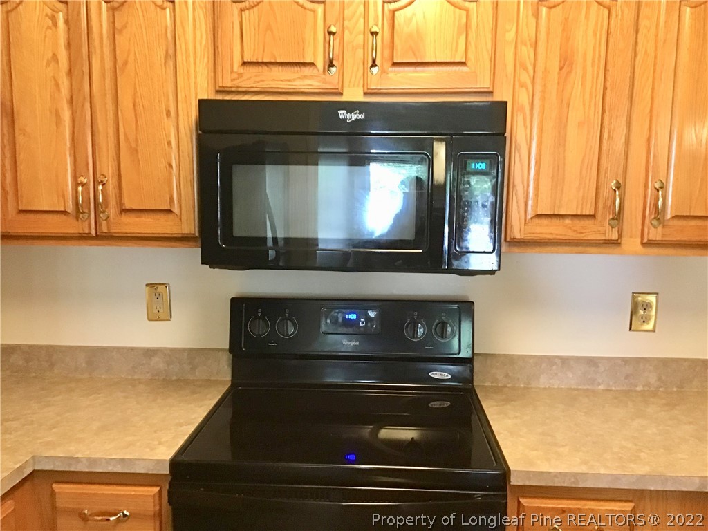 1824 Sardonyx Road, Unit 2 Fayetteville, NC 28303 - Photo 9 of 20 a stove top oven sitting inside of a kitchen