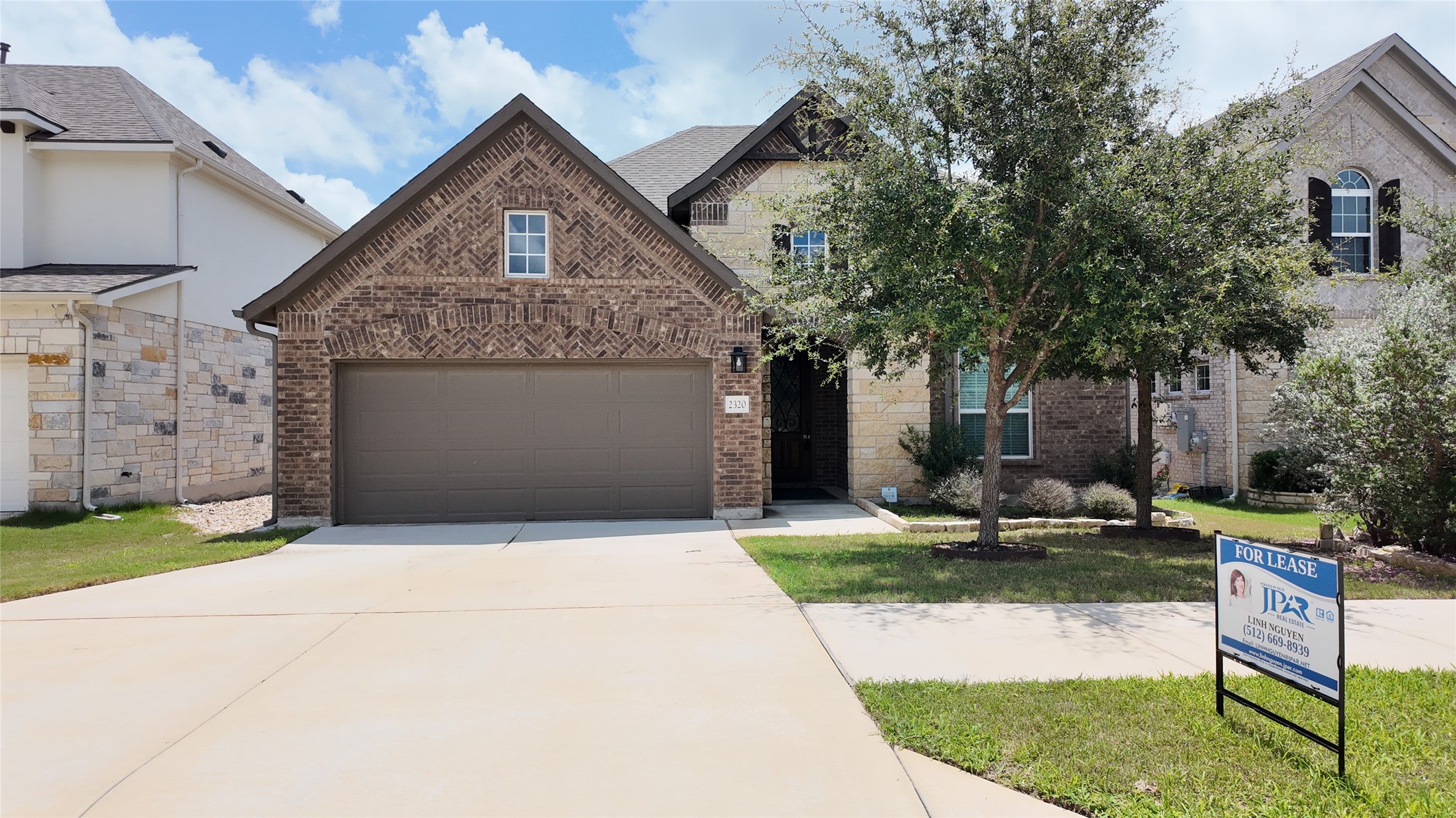 2320 Base Burner Path Leander, TX 78641 - Photo 1 of 24 Brick and stone exterior with mature trees creates a welcoming curb appeal.