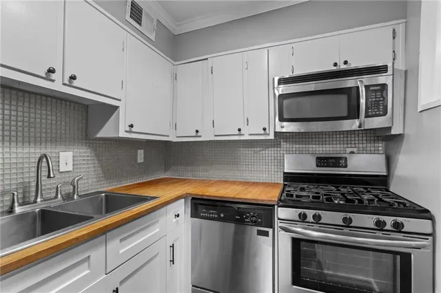 a kitchen with granite countertop a stove and a microwave