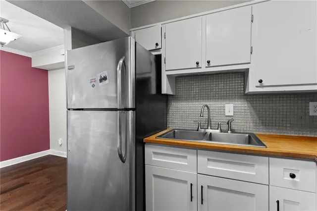 a kitchen with a sink and refrigerator