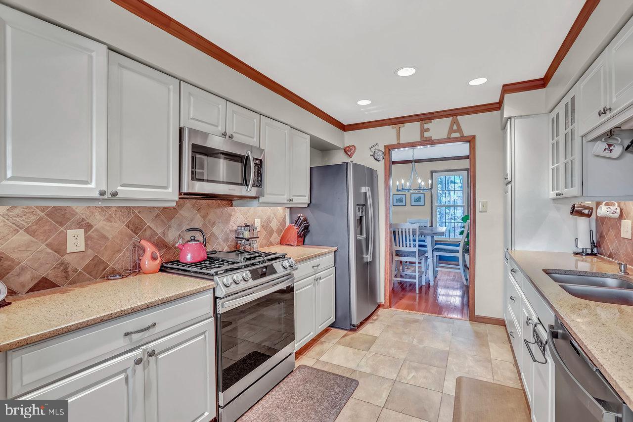 1 Washington Way Tabernacle, NJ 08088 - Photo 11 of 37 a kitchen with stainless steel appliances granite countertop a stove sink and cabinets
